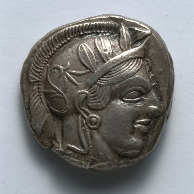 Obverse of an Athenian silver tetradrachm: Athena faces right in a crested helmet decorated with olive leaves.